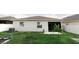 Backyard of home featuring well-maintained lawn and neutral-colored exterior at 414 Taft Dr, Davenport, FL 33837