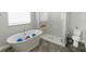 Bright bathroom with a standalone tub and glass-enclosed shower for a modern and functional space at 414 Taft Dr, Davenport, FL 33837