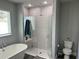 Bright bathroom showcasing a glass-enclosed shower, soaking tub, and updated fixtures at 414 Taft Dr, Davenport, FL 33837