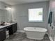 The bathroom features a double vanity, soaking tub, and walk-in shower at 414 Taft Dr, Davenport, FL 33837