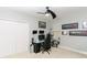Bedroom featuring double doors, neutral walls, carpet, and custom car art at 414 Taft Dr, Davenport, FL 33837