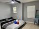 Bright bedroom with neutral walls, carpet flooring, and ample natural light from large windows at 414 Taft Dr, Davenport, FL 33837