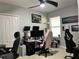 Functional bedroom featuring neutral walls, two computer setups, and ample natural light at 414 Taft Dr, Davenport, FL 33837