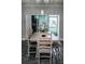 Elegant dining area with a rustic wooden table, stylish chairs, and sliding glass doors at 414 Taft Dr, Davenport, FL 33837