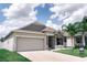 Inviting single-story home featuring a two-car garage, stone accents, and well-maintained landscaping at 414 Taft Dr, Davenport, FL 33837