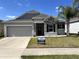 Charming single-Gathering home with stone accents, well-maintained landscaping, and a two-car garage at 414 Taft Dr, Davenport, FL 33837