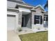 Charming single-Gathering home with a grey exterior, stone accents, and a well-manicured lawn at 414 Taft Dr, Davenport, FL 33837