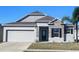 Charming single-Gathering home with stone accents, a well-manicured lawn, and a two-car garage at 414 Taft Dr, Davenport, FL 33837