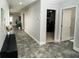 Spacious hallway featuring stylish tile flooring, neutral walls, and modern lighting fixtures at 414 Taft Dr, Davenport, FL 33837