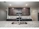 Kitchen with granite countertops, stainless steel appliances, dark cabinets, and a large sink at 414 Taft Dr, Davenport, FL 33837