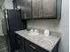 This kitchen features gray cabinets and granite countertops at 414 Taft Dr, Davenport, FL 33837