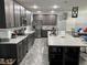 Modern kitchen with stainless steel appliances, granite countertops, a spacious island, and ample storage at 414 Taft Dr, Davenport, FL 33837