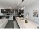 Open-concept space with kitchen and dining area featuring dark cabinets, granite countertops, and modern lighting fixtures at 414 Taft Dr, Davenport, FL 33837