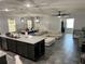 Open-concept living space with modern lighting, neutral colors, and seamless flow from the kitchen and dining area at 414 Taft Dr, Davenport, FL 33837