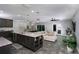 Open-concept living area with modern kitchen, granite countertops, and comfortable seating at 414 Taft Dr, Davenport, FL 33837