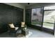 Cozy screened patio with outdoor seating, ceiling fan, and exterior door access at 414 Taft Dr, Davenport, FL 33837