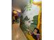 Hallway with incredible custom Disney-themed wall murals and tile floors at 434 Acacia Tree Way, Kissimmee, FL 34758