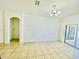 Bright, neutral living room with tile floors, decorative molding, and sliding glass doors leading to the outside at 434 Acacia Tree Way, Kissimmee, FL 34758