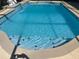 Inviting in-ground swimming pool with a beautiful blue tile and a patio surround for relaxing at 434 Acacia Tree Way, Kissimmee, FL 34758