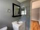 Bathroom with a white vanity, updated fixtures, and mirrors adding brightness to the area at 55808 Nan Dr, Astor, FL 32102