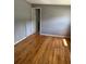 Bedroom with hardwood floors, neutral paint, and an open door to another room at 55808 Nan Dr, Astor, FL 32102