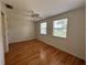 Bedroom featuring hardwood flooring, a ceiling fan and windows that bring in natural light at 55808 Nan Dr, Astor, FL 32102