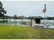 Scenic waterfront featuring a dock, boat, and lush water lilies, perfect for enjoying lakeside living at 55808 Nan Dr, Astor, FL 32102