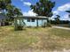 Charming single-story home with light blue siding and a well-maintained lawn at 55808 Nan Dr, Astor, FL 32102