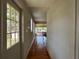 Hallway with wood floors leading to a room with large windows and a scenic outdoor view at 55808 Nan Dr, Astor, FL 32102