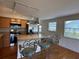 Stylish kitchen with stainless steel appliances, granite counters and breakfast bar with seating at 55808 Nan Dr, Astor, FL 32102