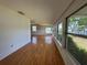 Open living room boasting hardwood floors, recessed lighting, and large windows overlooking the waterfront at 55808 Nan Dr, Astor, FL 32102