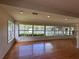Large living room with waterfront views from many windows and hardwood flooring at 55808 Nan Dr, Astor, FL 32102