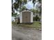 Outdoor shed, providing additional storage on the property by the water, and conveniently located near a trash receptacle at 55808 Nan Dr, Astor, FL 32102