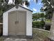 Durable outdoor storage shed and partial water view at 55808 Nan Dr, Astor, FL 32102
