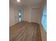 Bright bedroom with wood-look flooring and double closets at 645 Cherry St, Daytona Beach, FL 32114