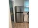 Stainless steel refrigerator in a kitchen with white cabinets and wood-look floors at 645 Cherry St, Daytona Beach, FL 32114