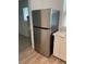 Stainless steel refrigerator in a kitchen with white cabinets and wood-look floors at 645 Cherry St, Daytona Beach, FL 32114