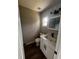 A bathroom with a toilet, vanity, and decorative lighting at 708 Wynn Dr, Sanford, FL 32773