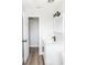 Modern bathroom featuring updated vanity, sleek fixtures, and an open doorway leading to a spacious closet at 708 Wynn Dr, Sanford, FL 32773