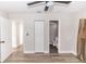 Well-lit bedroom features wood-look flooring, neutral walls, ceiling fan, closet, and an ensuite bathroom at 708 Wynn Dr, Sanford, FL 32773