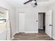 Bright bedroom with wood-look floors, neutral walls, ceiling fan, closet and natural light from a window at 708 Wynn Dr, Sanford, FL 32773