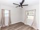 Light-filled bedroom offers wood-look flooring, neutral walls, a ceiling fan, and windows on two walls at 708 Wynn Dr, Sanford, FL 32773