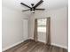 Bedroom with wood-look floors, neutral walls, ceiling fan, closet, and a window providing natural light at 708 Wynn Dr, Sanford, FL 32773
