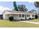 Inviting exterior view of this single Gathering home, featuring a carport, well maintained lawn, and freshly painted exterior at 708 Wynn Dr, Sanford, FL 32773