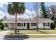 Charming single-story home featuring a palm tree, well-maintained lawn, and inviting curb appeal in a quiet neighborhood at 708 Wynn Dr, Sanford, FL 32773