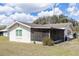 Exterior view of house, with a screened in porch and an ample backyard at 708 Wynn Dr, Sanford, FL 32773