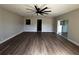 Expansive living room featuring sleek floors, modern fan and slider leading to a covered patio at 708 Wynn Dr, Sanford, FL 32773