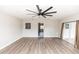 Well-lit living area featuring sleek flooring and seamless transition to the kitchen and sliding glass door to the outside at 708 Wynn Dr, Sanford, FL 32773