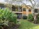 Two-story building with screened balconies and lush landscaping at 7654 Sugar Bend Dr # 7654, Orlando, FL 32819