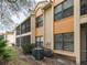 Back exterior view showcasing building and AC units at 7654 Sugar Bend Dr # 7654, Orlando, FL 32819